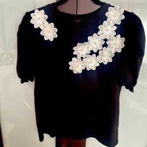 Elegant Black Top with White Floral Accents